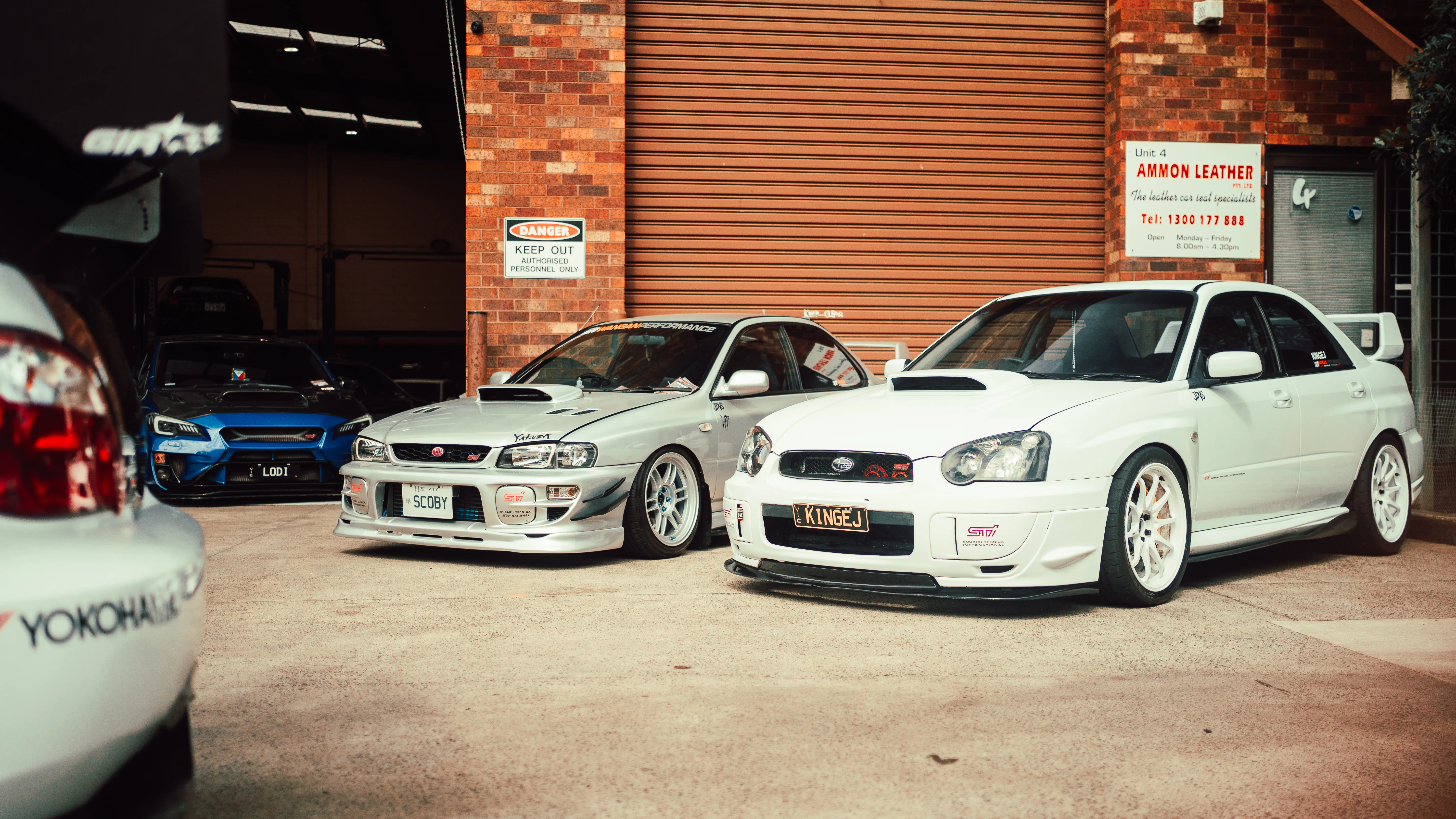 Subaru WRX and STI lined up outside the Wangan Performance workshop