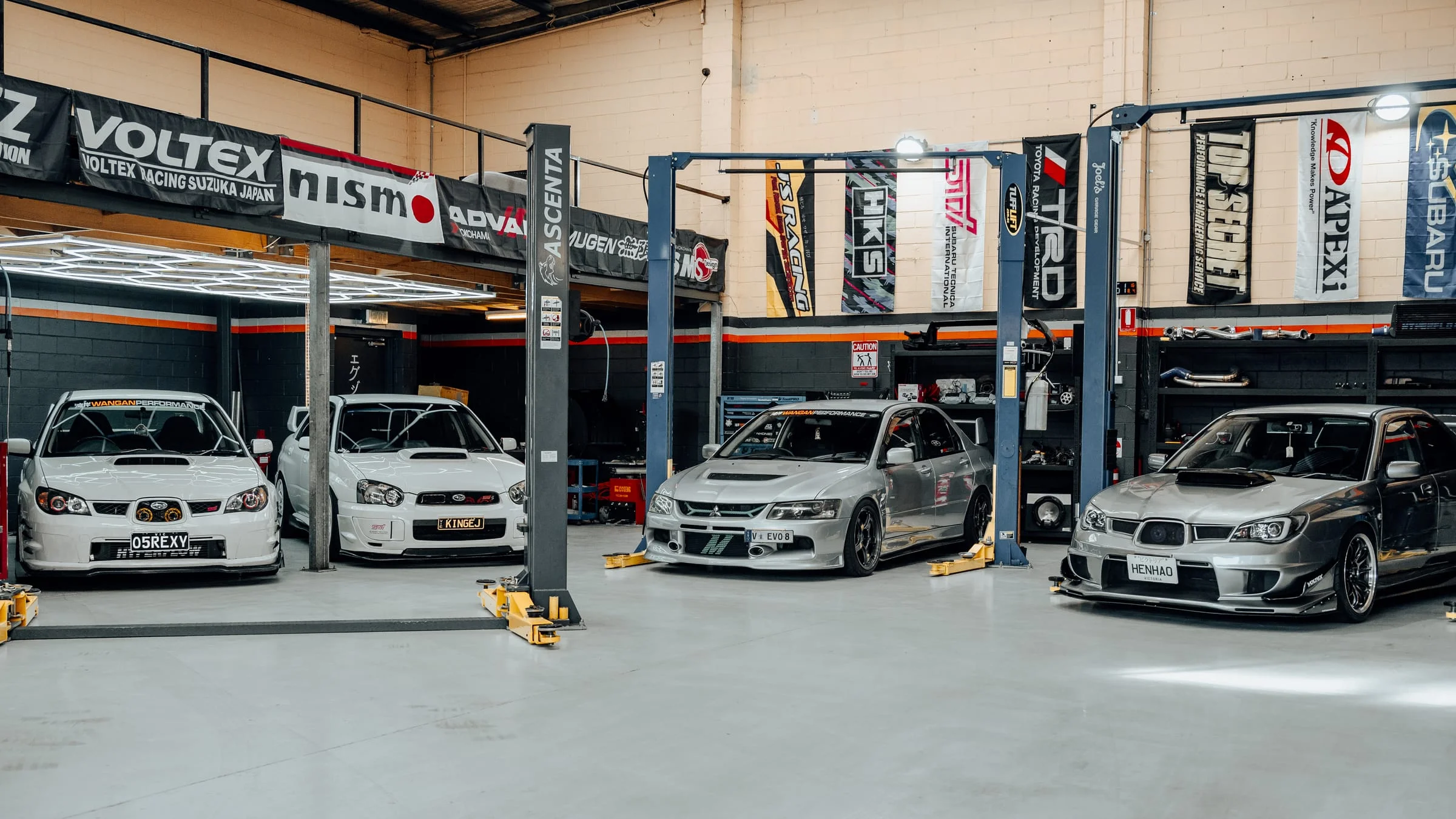 Four cars inside the Wangan Performance workshop in Oakleigh South